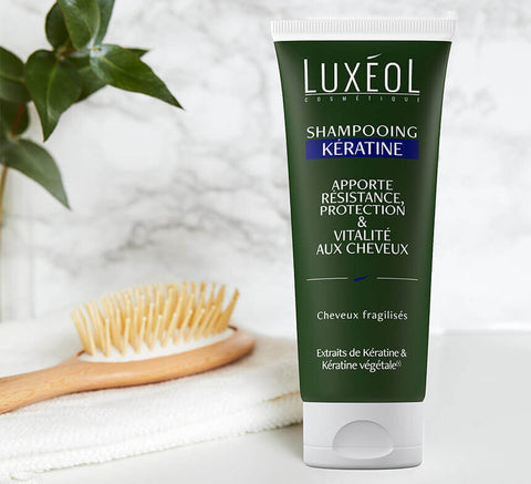 Keratin Shampoo lifestyle shot beside brush and towel, use 2–3 times weekly, pair with Keratin Mask.