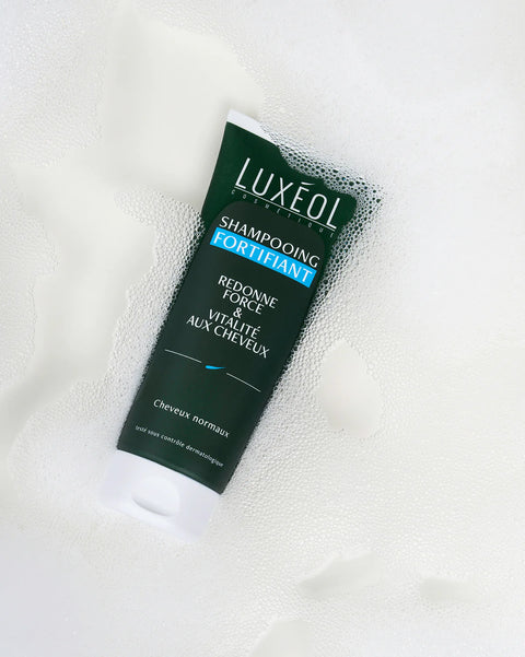 Luxeo shampoo tube on a white background
