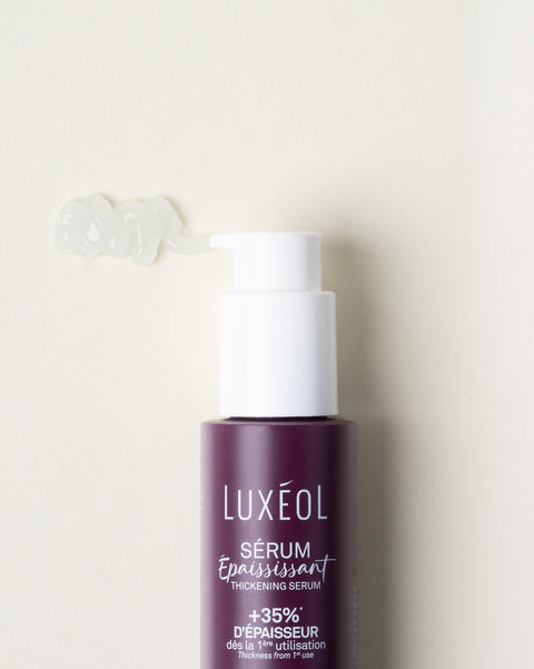 Luxéol serum bottle with pump on a beige background
