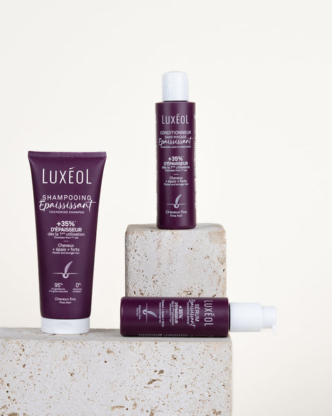 Luxéol hair care products on a stone block with a white background